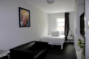 a living room with a bed and a couch at Comfortable Studio in Back Bay, Newbury St. #7 in Boston