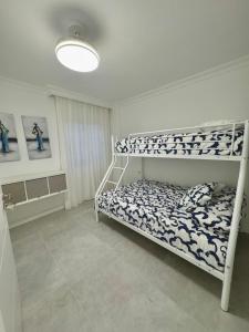 a bedroom with a bunk bed in a room at CASA TINA piscina privada in Candelaria