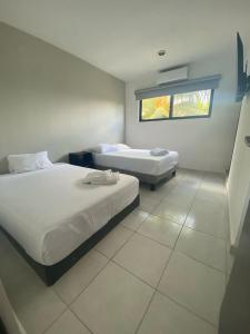 Postel nebo postele na pokoji v ubytování Hotel Suites La Maya