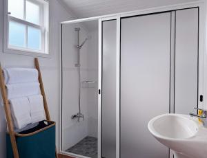 a bathroom with a glass shower and a sink at Casa do Cacto - 2 Bedroom Apartment in Madalena