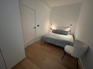 a small bedroom with a bed and a chair at Bilbao City Center in Bilbao +5 photos