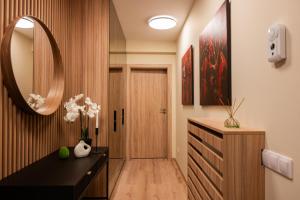 a hallway with a mirror and a dresser in a room at MAROVA LUXURY APARTAMENT Caraiman VIEW in Buşteni