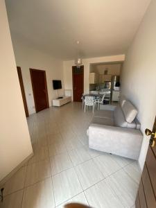 a large living room with a couch and a kitchen at Villa Agavi in Formia