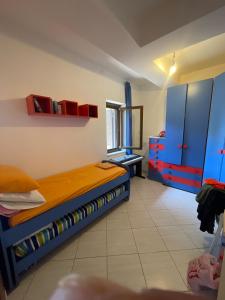 a bedroom with two bunk beds and blue cabinets at Villa Agavi in Formia