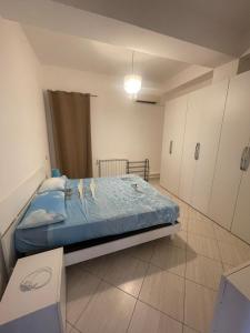 a bedroom with a bed in a room with cabinets at Villa Agavi in Formia