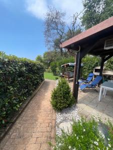 a patio with a pavilion and a table and chairs at Villa Agavi in Formia +20 photos