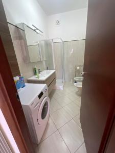 a bathroom with a washing machine and a sink at Villa Agavi in Formia