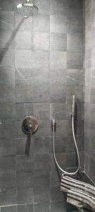 a bathroom with a shower with a glass door at Le Jasmin Appartement in Dar el Haj Ahmed Souid