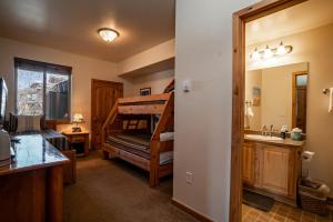 a bathroom with a bunk bed and a sink in a room at Trailhead Lodges 511, a spacious 2-bedroom condo in the heart of Winter Park in Winter Park +55 photos