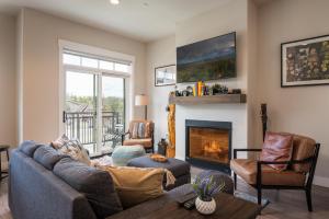 a living room with a couch and a fireplace at Hideaway Station TS 23 - New in Downtown Winterpark in Winter Park