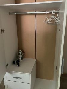a closet with a white cabinet and a door at The art place in Vidin