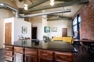 a kitchen with a counter top in a room at Industrial Escape 2bd 2bath in Lawrence +47 photos