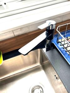 a kitchen sink with a faucet on top of it at Stylish and Spacious two-bedroom Apartment in Blackpool