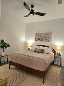 a bedroom with a bed with a ceiling fan at Wabi Sabi in Lawrence