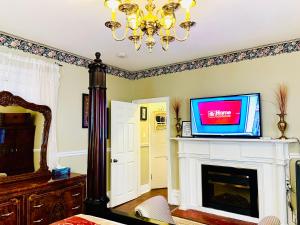 a living room with a tv on top of a fireplace at Barker House 3# Suite-heart of oldtown in Niagara on the Lake