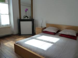 a bedroom with a large bed and a window at Les Carrés in Versailles