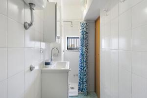 a white bathroom with a sink and a shower at Bluegreen 2 Apartments Amalfi Coast in Maiori +37 photos