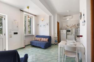 a living room with a blue couch and a table at Bluegreen 2 Apartments Amalfi Coast in Maiori