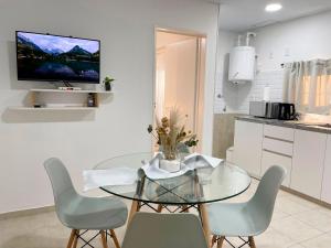 a dining room with a glass table and chairs at Dalia Pampa in RSA