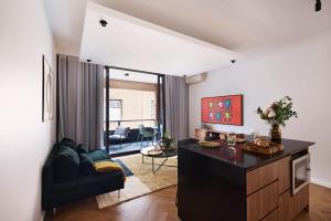 a living room with a couch and a table at The Brass Flamingo on Oxford Street in Sydney