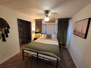 a bedroom with a bed in a room at Grandma's House at Rosewood Lodge in Iola