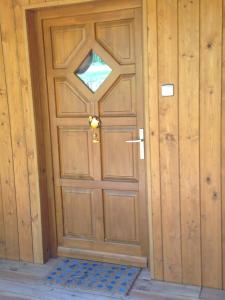 a wooden door with a knocker on it at Premium "Vintage" Apartment in Zalaszentmihály