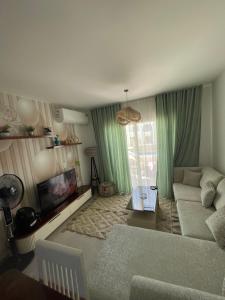 a living room with a couch and a tv at Mountain view north coast in Banī Ghālib