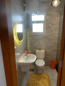 a small bathroom with a toilet and a sink at Mountain view north coast in Banī Ghālib +5 photos