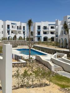 a swimming pool in front of a building at Mountain view north coast in Banī Ghālib