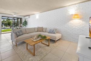 a living room with a couch and a table at 3-Bed Waterfront Apartment with Private Patio in Mooloolaba