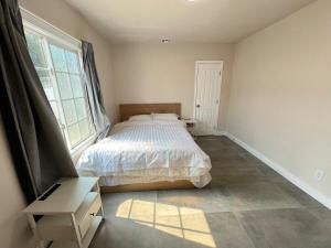a bedroom with a bed and a window at Fully Remodeled 2B1B Home in Baldwin3369 in Baldwin Park