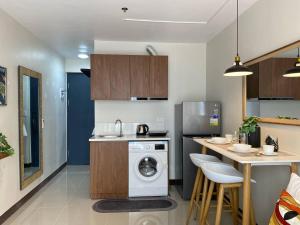 a kitchen with a washing machine and a counter at Moonlight Chic Living in Lapu Lapu City