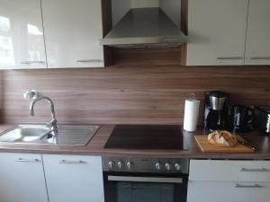 a kitchen with a sink and a stove top oven at Geschmackvolle Wohnung in Offenbach in Offenbach
