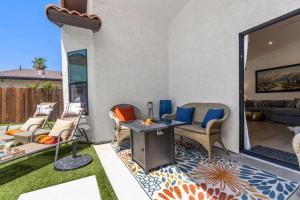 a patio with chairs and a table on a patio at La Quinta Cove Oasis - Pool,Spa,Hiking,Tennis,Golf,Stagecoach and Coachella! in La Quinta +36 photos