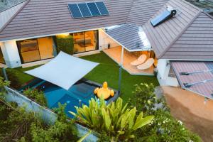 an overhead view of a house with a swimming pool at Villa Aura Chiang Mai in Chiang Mai
