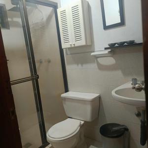 a bathroom with a toilet and a sink at HOSTAL - COLIVING - Cerca MetroCable ARVI in Guarne +33 photos