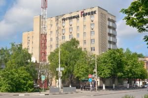 a tall building with a crane in front of it at Gornyak Hotel in Shakhty