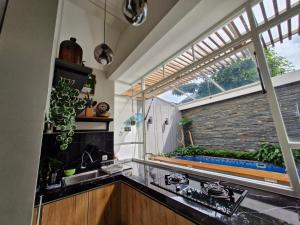 a kitchen with a sink and a window at Ciara Villa with private pool in Batu