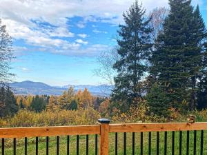 a wooden fence with a view of the mountains at Le Camp Perché #2 in La Malbaie