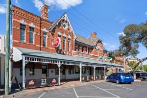 a building with a car parked in front of it at Euroa Hotel in Euroa