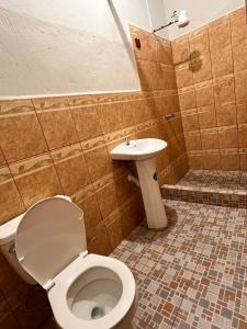 a bathroom with a toilet and a sink at Hotel Casa don Angel in Las Victorias