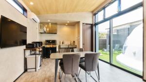 a kitchen and dining room with a table and chairs at Mt FUJI RESORT GLAMPING Yamanakako in Yamanakako