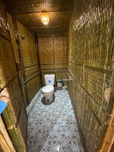 a small bathroom with a toilet in a stall at Thiên Cẩm Sơn Camping-Homestay Núi Cấm in Phum Cần Chai Krom