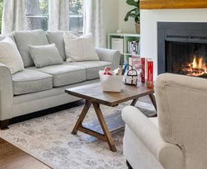 a living room with a couch and a fireplace at GreenBNB in Locust Grove +25 photos