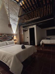 Postel nebo postele na pokoji v ubytování Hotel Hacienda Anacaona - San Agustín