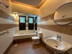 a bathroom with a sink toilet and a mirror at JB home Mount Austin SemiD near Toppen IKEA Aeon fix to 14pax in Johor Bahru +22 photos