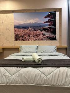 a bed with two towels on top of it at JB home Mount Austin SemiD near Toppen IKEA Aeon fix to 14pax in Johor Bahru