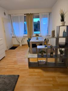 a living room with a table and some windows at LaCasa-Mia Apartment Basel in Basel +23 photos