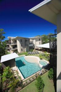 an external view of a swimming pool in front of a building at Agnes Water Beach Club in Agnes Water