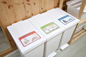 two white tables with stickers on them in a room at 沖縄古民家 Villa JYANA in Nakijin